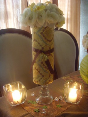 This centerpiece is just a simple glass cylinder wrapped in scrap book paper