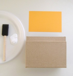 Glue to adhere paper to box.