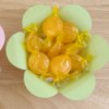 Pastel colored paper flower shaped bowl with candy