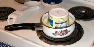 Tub of butter upside down in saucepan