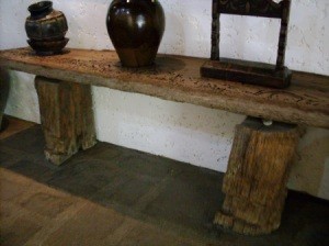 handmade table with base made from two halves of a tree trunk