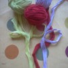 three balls of the t-shirt strips in green, blue, and maroon