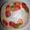 View of interior of bowl with eleven cut outs of bell peppers arranged artfully overlapping each other and the 