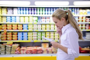 A woman looking at her shopping list.