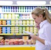 A woman looking at her shopping list.