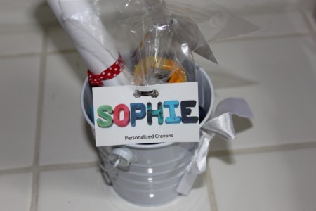 Goodie bag with label showing name in crayons against white background