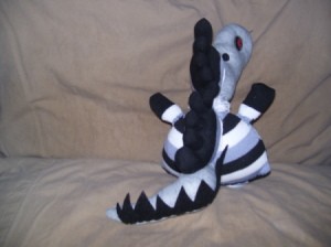 Black, white, and gray creature from the rear. Here the tail is clearly visable.