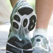 A picture of the feet of a woman in running shoes.