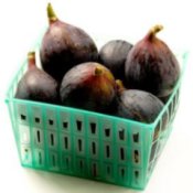 Green plastic basket of fresh figs.