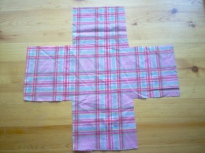 Plaid fabric cut into a plus sign shape