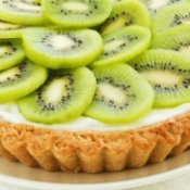 Kiwi tart on a white plate.