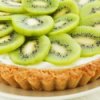 Kiwi tart on a white plate.
