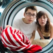 Picture of a red striped shirt in a washer.
