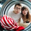 Picture of a red striped shirt in a washer.