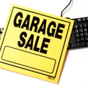 Garage Sale sign laying over top of a black keyboard