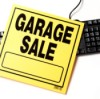 Garage Sale sign laying over top of a black keyboard