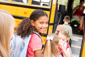 Girl Getting on the Bus to go Back to School