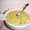Soup bowl with Broccoli Cheese Noodles and a spoon