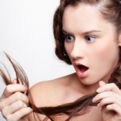 Girls looking at Her Braided Hair with Split Ends