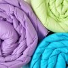 Three comforters rolled up.