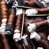 Curlers in brunette hair for a perm.