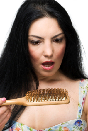 Woman Looking Shocked at the Hair in Her Brush