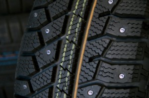 Saving Money on Studded Tires, A close up of the studs on the tread of a snow tire.