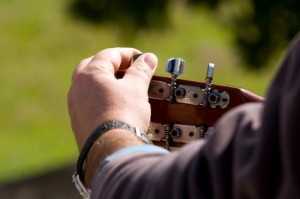 Man Tuning His Guitar