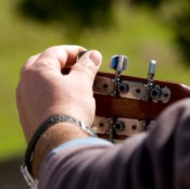 Man Tuning His Guitar