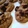 A batch of chocolate chip cookies on a baking tray.