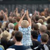 Child Clapping in Crowd at Festival