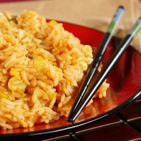 Plate of fried rice with chopsticks.