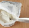 Uses for Yogurt Containers, Open Yogurt Container With spoon in it.