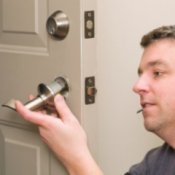 Man Replacing a Doorknob