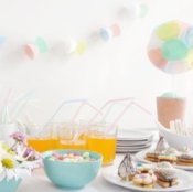 Decorations and food on a table at a baby shower.