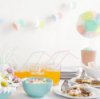 Decorations and food on a table at a baby shower.