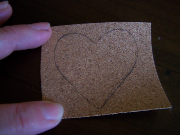 square piece of cork with heart traced on it