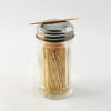 Toothpicks in a glass spice jar.
