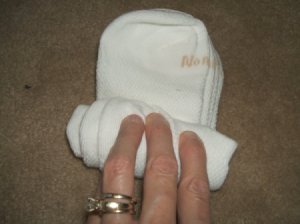 Hand rolling up two pairs of socks