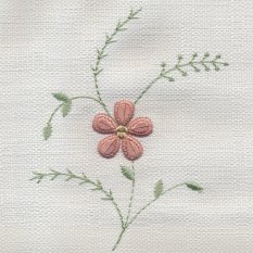 Floral needlework on white fabric.
