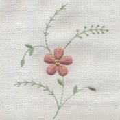 Floral needlework on white fabric.