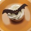 A bat decoration on top of a cupcake.