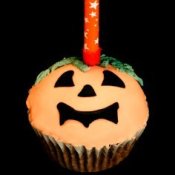 Cupcake decorated as a jack-o-lantern.