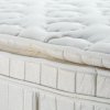 Up close photo of a pillow top mattress.