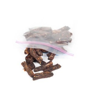 Pieces of beef jerky spilling out of a plastic storage bag.