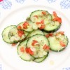 A plate of cucumber salad, ready to be eaten.