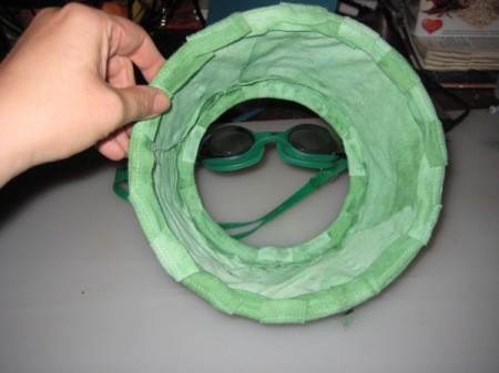 Goggles Being Held up Behind Cone