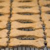 Rows of homemade dog biscuits cooling on a rack.