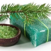 Making Homemade Soap, Bar of natural pine soap, with a pine branch, and a dish of green sea salt.