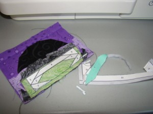 Removing foundation paper after sewing parts A and B together.